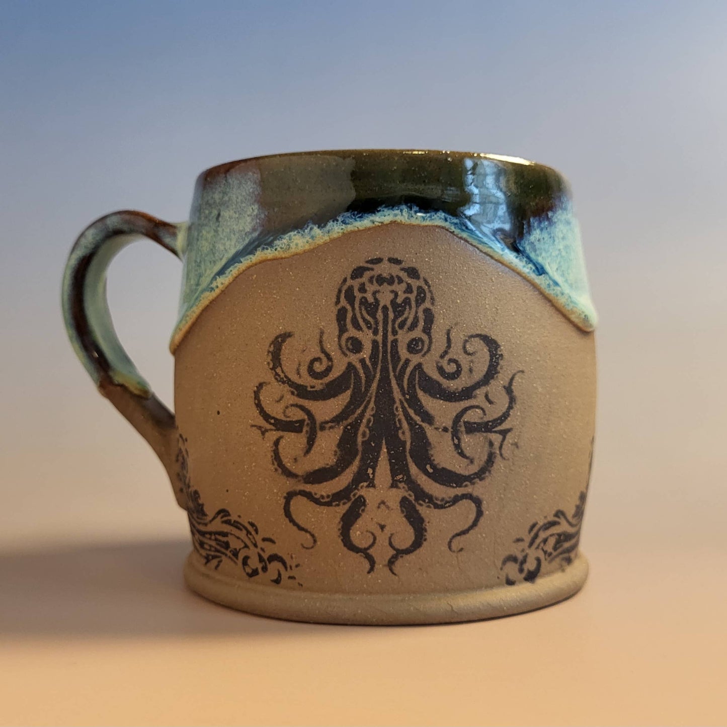 Divine Vessels Pottery - Octopus mug coastal design with wave glaze and sandy texture